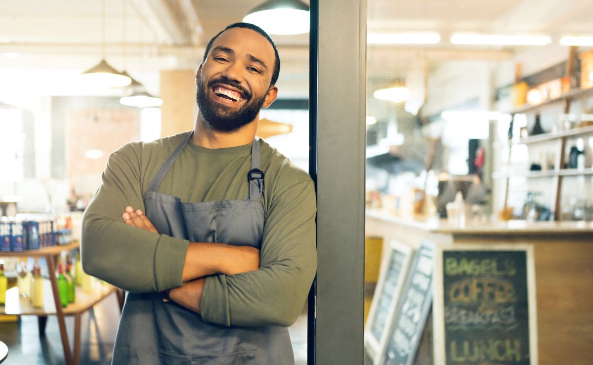 Cheerful man working in coffee shop 2026 01 09 09 44 24 utc